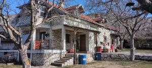 an old stone house with a tree in front of it at Residence "Ana Pletvarska" in Prilep
