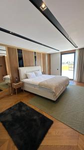 a bedroom with a large bed and a large window at Royal Garden 7 Villas in Dosemealti