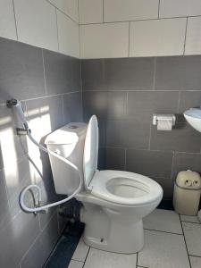 a bathroom with a white toilet and a sink at Nadi Homes in Dar es Salaam