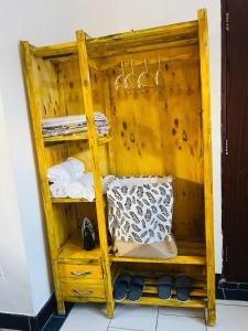 a wooden shelf with towels and towels on it at Nadi Homes in Dar es Salaam