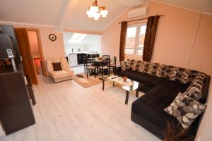 a living room with a couch and a table at Marinero Apartments in Kotor
