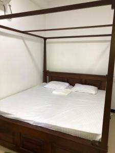 a bed with two white pillows on top of it at Haven house with AC in Kamburugamuwa