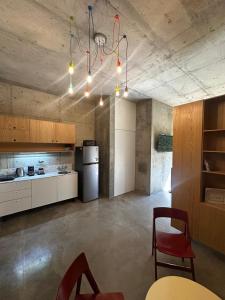 a large room with a kitchen with a refrigerator at Stylish apartment in Chapultepec in Guadalajara +26 photos
