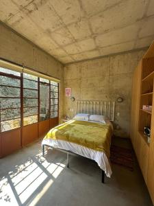 a bedroom with a bed in the corner of a room at Stylish apartment in Chapultepec in Guadalajara