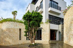 a tree in front of a building at Aahana Village Bali in Canggu