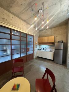 a kitchen with two chairs and a table and a refrigerator at Stylish apartment in Chapultepec in Guadalajara
