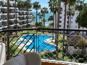 a balcony with a view of a swimming pool at Mi Capricho, Luxury Apartment in Mijas Costa