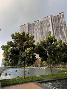 a swimming pool in front of a large building at RoomBnB MVertica in Kuala Lumpur