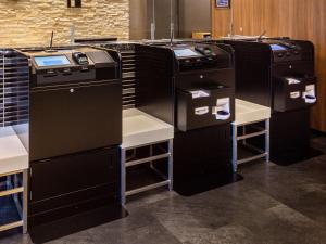 a room with three black appliances in a kitchen at Comfort Hotel Nara in Nara