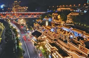 a city at night with a bridge in the background at Kaibu Courtyard Superior Apartment, Changjiang Cable Car Nanbin Road, Chongqing in Chongqing