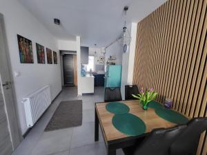 a living room with a wooden table and chairs at Słoneczny Apartament Władysławowo dla 6 osób in Władysławowo