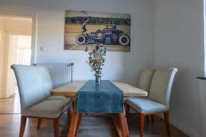 a dining room table with a vase of flowers on it at 3BR - City Apartments - Kitchen - 10 min to ICE in Siegburg