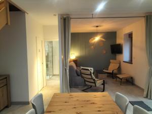 a living room with a table and chairs at La petite favière in Cult