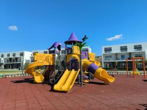 a row of playground equipment on a sidewalk at Spacious & Bright 2BR Apartment, 5min to Beach in Boghaz