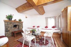 a living room with a bed and a fireplace at Eagle Woods Kookal in Kūkkāl +45 photos