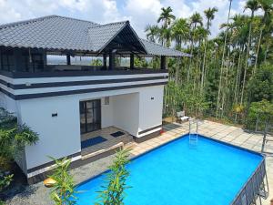 a villa with a pool and a gazebo at mountain lake view private pool villa -Wayanad in Meppādi