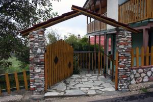 an entrance to a house with a wooden gate at Guesthouse Mitsiopoulou in Neochori