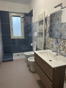 a bathroom with a sink and a toilet and a shower at Salerno BellaVista in Salerno
