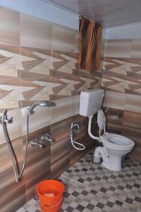 a bathroom with a toilet and a shower at Sunleo Villas in Anachal +31 photos