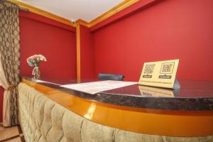 a table in a room with a red wall at Da Vinci Hotel in Almaty