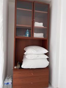 a wooden cabinet with white pillows in it at Cœur de Nice in Nice