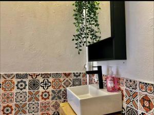 a bathroom with a sink and a tile wall at Chenang Beach's Nordic House in Pantai Cenang +19 photos