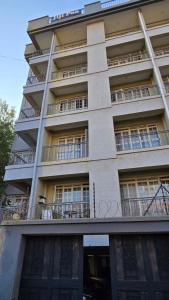 a tall building with balconies on the side of it at Affordable Luxury Ruaka in Ruaka