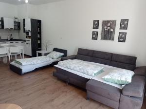 a living room with a couch and a table at WITH LOVE Marienbad Ap Garden 2 in Mariánské Lázně