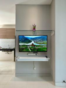 a flat screen tv on a wall in a living room at City side retreat Adelaide house in Tambakmanukan