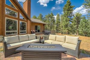 a patio with two couches and a fire pit at Colorado Lux Private Cabin Hot Tub Game Room A in Woodland Park