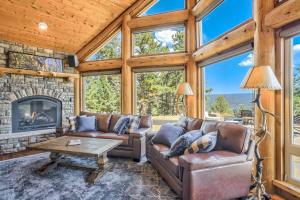 a living room with a couch and a fireplace at Colorado Lux Private Cabin Hot Tub Game Room A in Woodland Park +104 photos