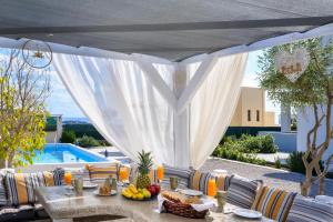 a table with fruit on it next to a pool at Calm and Joy Summer House in Afantou