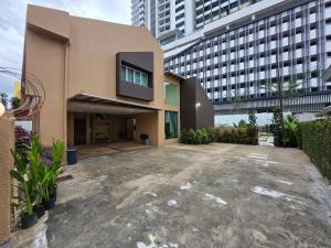 an empty parking lot in front of a building at Bungalow Perkasa in Kuala Lumpur