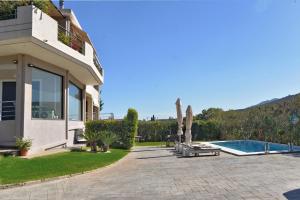 a villa with a swimming pool and a house at Villa Constangie in Marathon