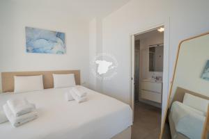 a bedroom with a white bed and a mirror at CostaBlancaDreams Calpe Beach in Calpe in Alicante +16 photos