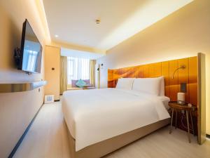 Katil atau katil-katil dalam bilik di 西安北站市政府漫心酒店