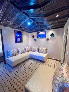 a living room with a couch and blue ceilings at Gite ECOPARADIS in Madagh +48 photos