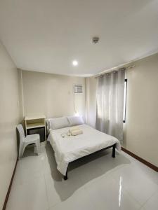a hospital room with a bed and a chair at pacific paradise apartment in Ubay