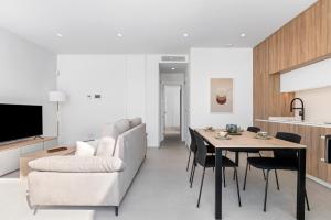 a kitchen and living room with a table and a couch at Villa Buba in Pilar de la Horadada