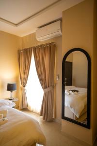 a bedroom with a mirror and a bed at Just Move Luxury 1BR APT, Near ISB Int'l AIRPT in Islamabad