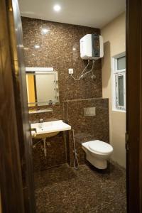 a bathroom with a toilet and a sink at Just Move Luxury 1BR APT, Near ISB Int'l AIRPT in Islamabad +24 photos