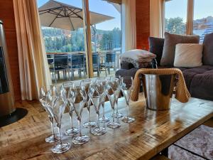 a group of wine glasses on a table in a living room at Chalet la Cime in Le Dévoluy