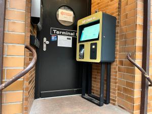 a pay phone on the side of a brick building at Urban Home Self Check-In Hotel in Hamburg