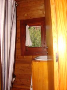 a bathroom with a toilet and a window at Cabana de Santo António in Vila Nova de Cerveira