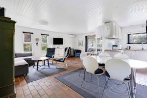 a kitchen and living room with a table and chairs at Cosy Holiday Home - 300 Meter From The See in Humble