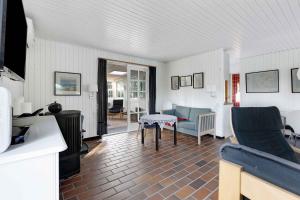 a living room with a table and chairs at Cosy Holiday Home - 300 Meter From The See in Humble