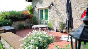 a patio with a table and chairs and an umbrella at Haus Norderteich in Horn-Bad Meinberg