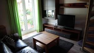 a living room with a television and a coffee table at Haus Norderteich in Horn-Bad Meinberg