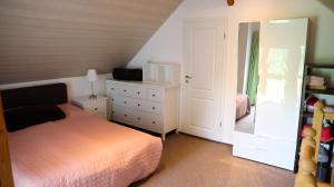 a bedroom with a bed and a dresser with a mirror at Haus Norderteich in Horn-Bad Meinberg