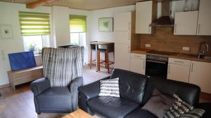 a living room with a couch and chairs in a kitchen at Haus Norderteich in Horn-Bad Meinberg